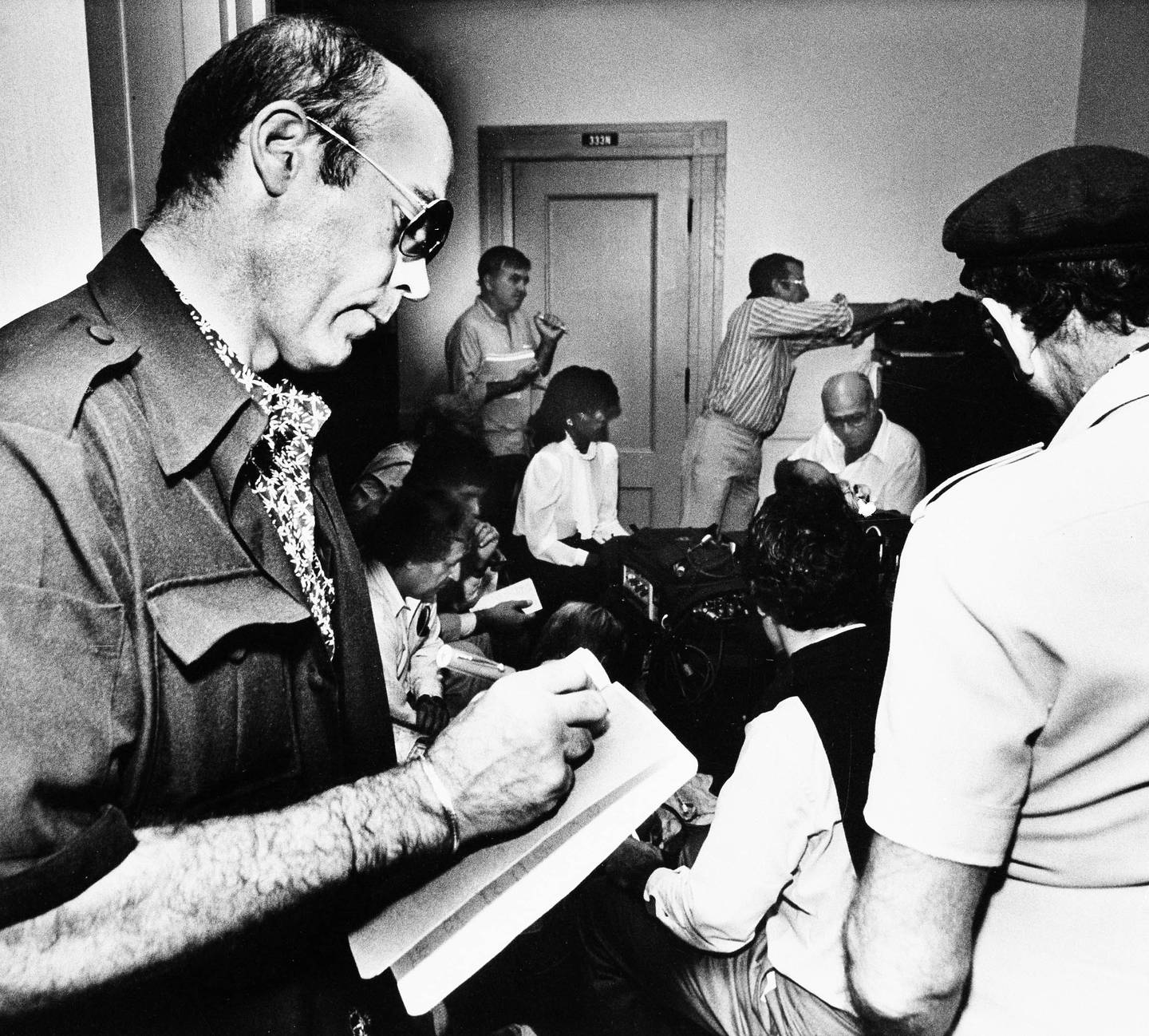 Hunter S. Thompson, Rolling Stone writer and author, checks his notes as he listens to testimony during Pulitzer trial in West Palm Beach, Fla.. November 4, 1982. Reporters from three continents have converged on the courthouse in Palm Beach to cover the trial. (AP Photo/Ray Fairall)