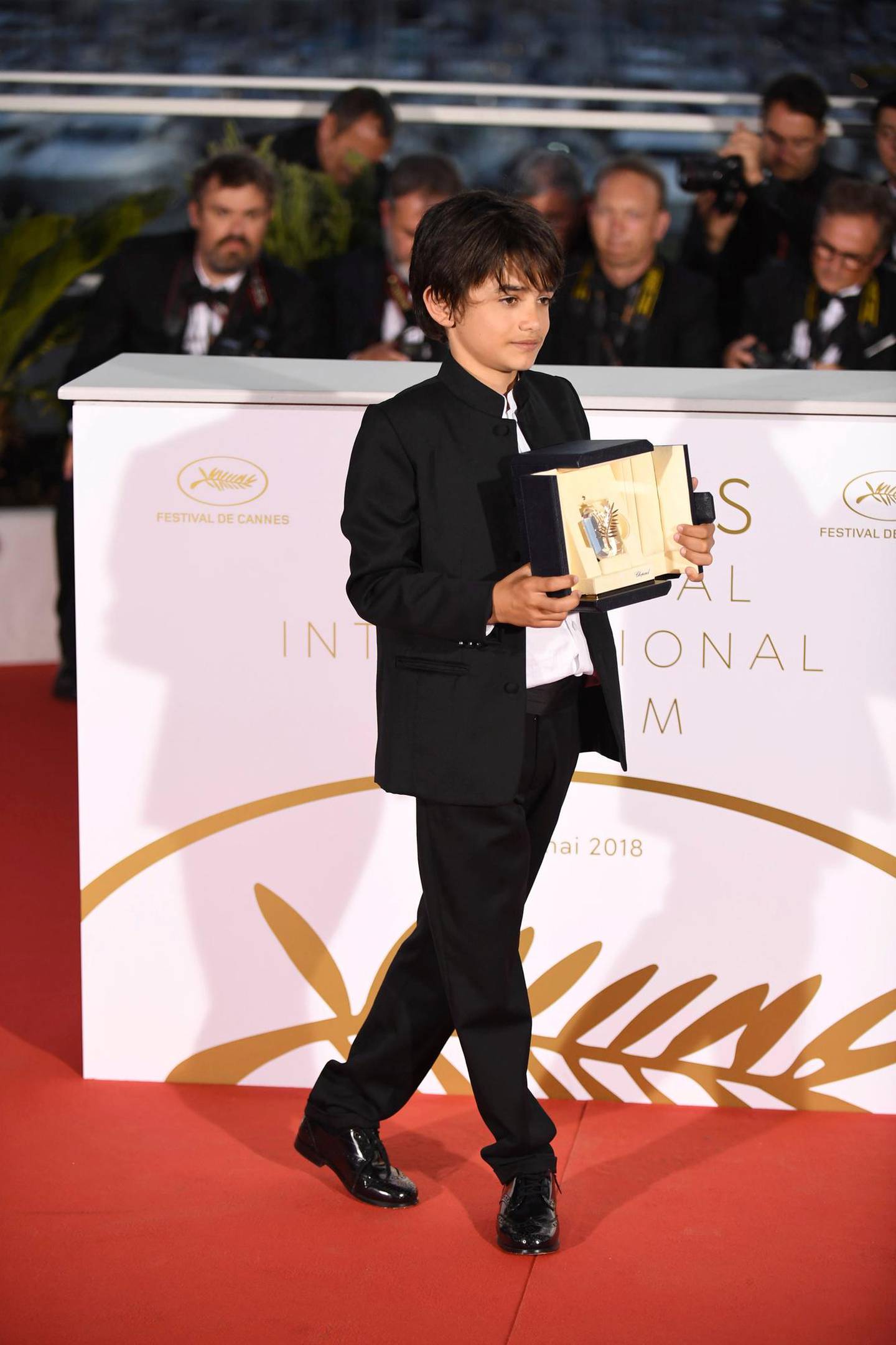 Actor Zain Al Rafeea poses during a photo call with the Jury Prize award for the film 'Capharnaum' following the awards ceremony at the 71st international film festival, Cannes, southern France, Saturday, May 19, 2018. (Photo by Arthur Mola/Invision/AP)
