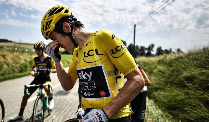 Great Britain's Geraint Thomas cleans his eyes after tear gas was used during a farmers' protest who attempted to block the stage's route, during the 16th stage of the 105th edition of the Tour de France cycling race, between Carcassonne and Bagneres-de-Luchon, southwestern France, on July 24, 2018. 
The race was halted for several minutes on July 24 after tear gas was used as protesting farmers attempted to block the route. / AFP PHOTO / Marco BERTORELLO