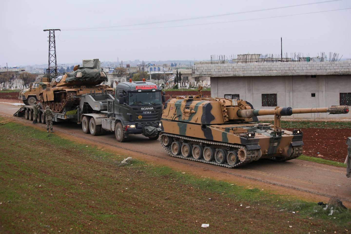 Turkish military convoy is seen near the town of Idlib, Syria, Wednesday, Feb. 12, 2020. Turkish President Recep Tayyip Erdogan said Wednesday that Turkey will attack government forces anywhere in Syria if another Turkish soldier is injured. (AP Photo/Ghaith Alsayed)