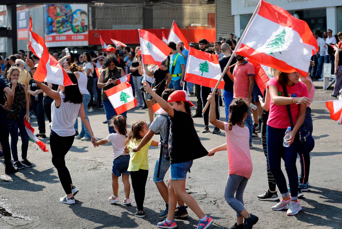 Lebanese school children join protests in the area Zouk Mosbeh, north of the capital Beirut, on October 21, 2019, as demonstrations against corruption continue for a fifth day. - Lebanon's teetering government is expected today to approve a belated economic rescue plan as the nation prepared for a fifth day of mass protests against the ruling elite.
A proposed tax on mobile messaging applications last week sparked a spontaneous, cross-sectarian mobilisation that has brought Lebanon to a standstill and put the entire political class in the dock. (Photo by JOSEPH EID / AFP)
