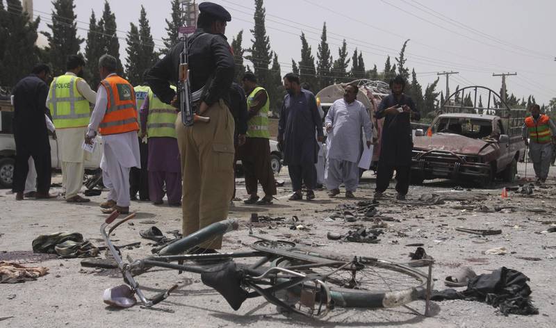 Pakistani security personnel visit the site of bombing in Quetta, Pakistan, Wednesday, July 25, 2018. A suicide bomber struck outside a crowded polling station in Pakistan's southwestern city of Quetta, killing many people as Pakistanis cast ballots Wednesday in a general election. (AP Photo/Arshad Butt)