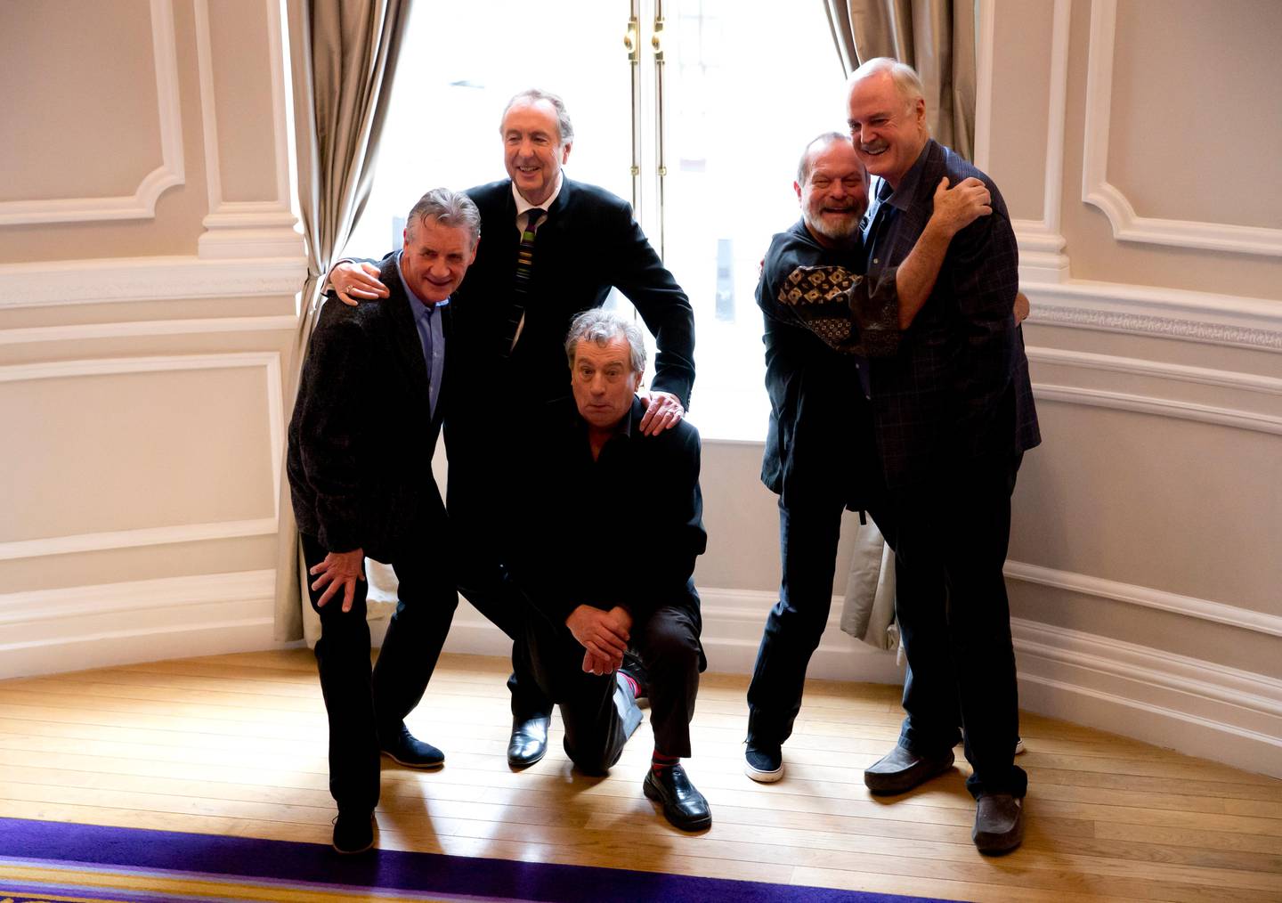 The surviving members of the Monty Python comedy group, from left, Michael Palin, Eric Idle, Terry Jones, Terry Gilliam and John Cleese pose for photographers during a photocall to promote a reunion stage show they are going to perform together, at a hotel in London, Thursday, Nov. 21, 2013.  The group had its first big success with the Monty Python's Flying Circus TV show, which ran from 1969 until 1974, winning fans around the world with its bizarre sketches.   (AP Photo/Matt Dunham)