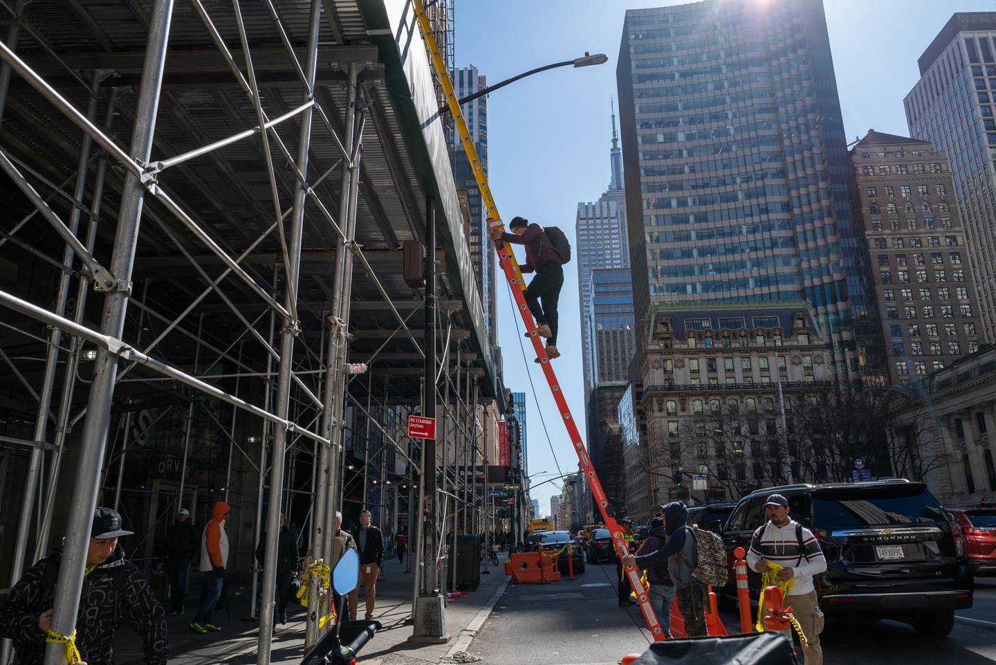 NEW YORK, NEW YORK - MARCH 30: A man walks down a construction ladder in a busy midtown Manhattan on March 30, 2023 in New York City. In a new report by the U.S. Census Bureau released today, the population of several major U.S. cities has started to show signs of growth after a decline during the coronavirus pandemic. New York County, which encompasses Manhattan, added more than 17,000 residents in the year ending last July. The county had lost more than 110,000 residents in the previous 12-month period.   Spencer Platt/Getty Images/AFP (Photo by SPENCER PLATT / GETTY IMAGES NORTH AMERICA / Getty Images via AFP)