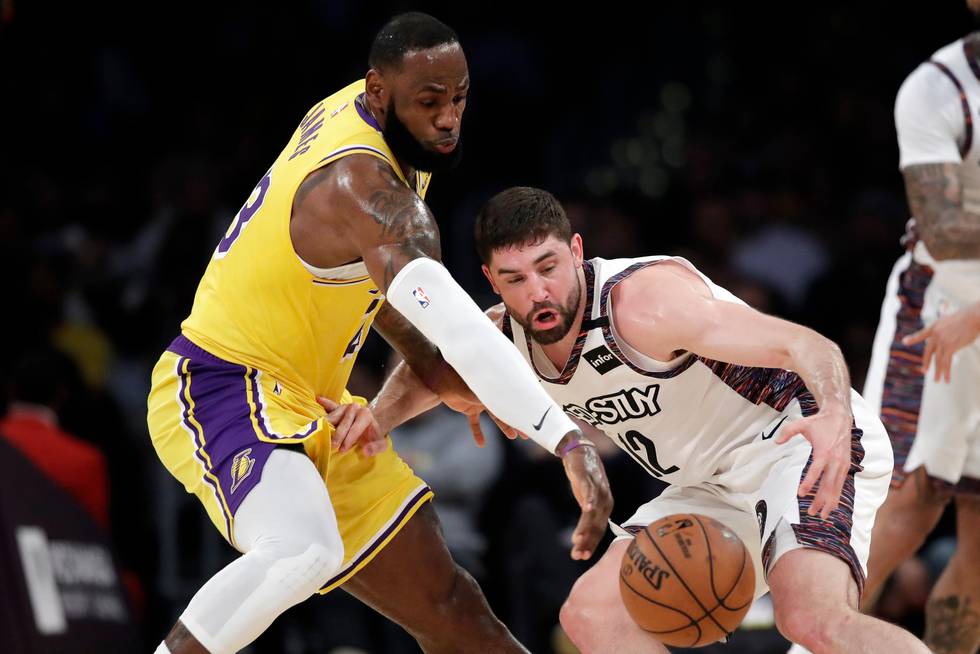 Los Angeles Lakers' LeBron James, left, strips the ball from Brooklyn Nets' Joe Harris during the first half of an NBA basketball game Tuesday, March 10, 2020, in Los Angeles. (AP Photo/Marcio Jose Sanchez)