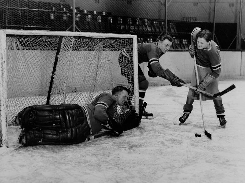 Mildred Babe Didrikson, right, works out with the New York Rangers players Murray Murdock, center, and Andy Aitkenhead, goalie, in Madison Square Garden in New York City, Jan. 7, 1933.  (AP Photo)