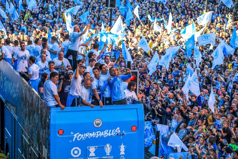 Manchester City players and staff take a selfie on the bus during the trophy parade in Manchester, England, Monday May 20, 2019, after winning the English FA Cup. Victory for Pep GuardiolaÄôs side came a week after the English Premier League trophy was retained to join the League Cup and Community Shield already in CityÄôs possession. (Peter Byrne/PA via AP)
