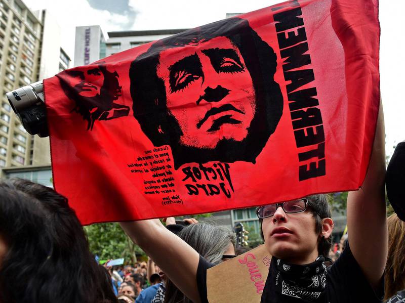 En demonstrant bærer en banner med protestsangeren Victor Jara, som ble torturert til døde av Pinochet-regimet i september 1973, i en demonstrasjon i Santiago i Chile i oktober 2019.
FOTO: NTB SCANPIX