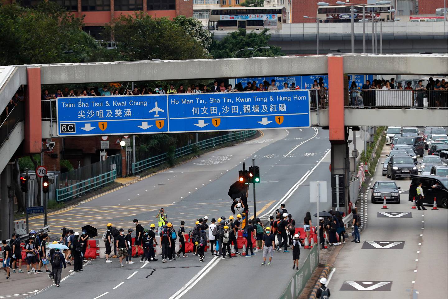 Protesters place barricades on a highway during a demonstration in Hong Kong, Saturday, Aug. 3, 2019. Hong Kong protesters ignored police warnings and streamed past the designated endpoint for a rally Saturday in the latest of a series of demonstrations targeting the government of the semi-autonomous Chinese territory. (AP Photo/Vincent Thian)