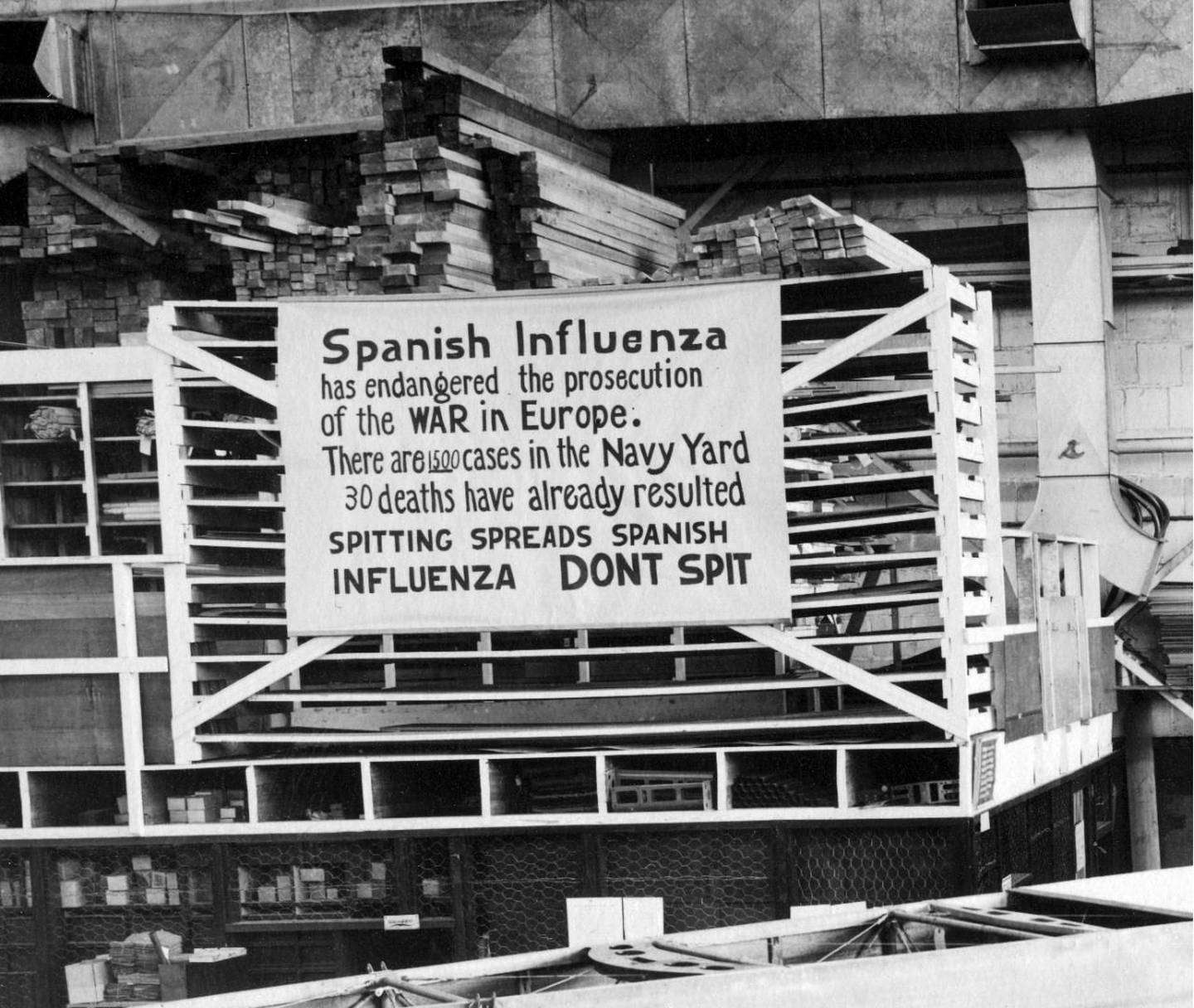 FILE - In this Oct. 19, 1918 file photo provide by the U.S. Naval History and Heritage Command a sign is posted at the Naval Aircraft Factory in Philadelphia that indicates, the Spanish Influenza was then extremely active. Science has ticked off some major accomplishments over the last century. The world learned about viruses, cured various diseases, made effective vaccines, developed instant communications and created elaborate public-health networks. Yet in many ways, 2020 is looking like 1918, the year the great influenza pandemic raged. (U.S. Naval History and Heritage Command via AP)
