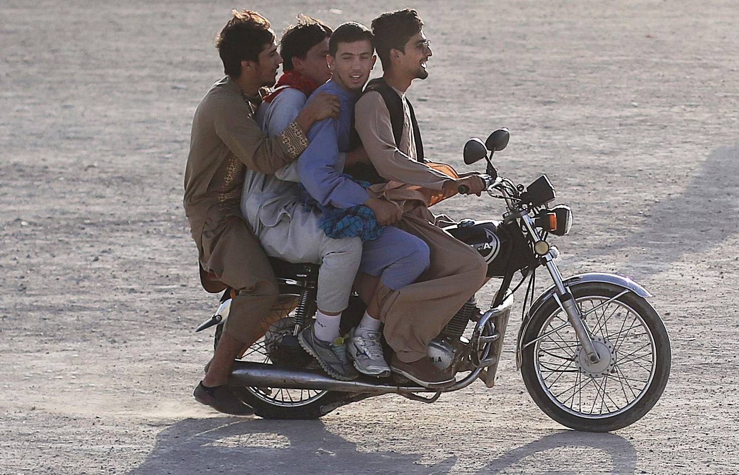 Afghan boys ride a bike in Kabul,Afghanistan, Friday, Aug. 2, 2019.(AP Photo/Rafiq Maqbool)