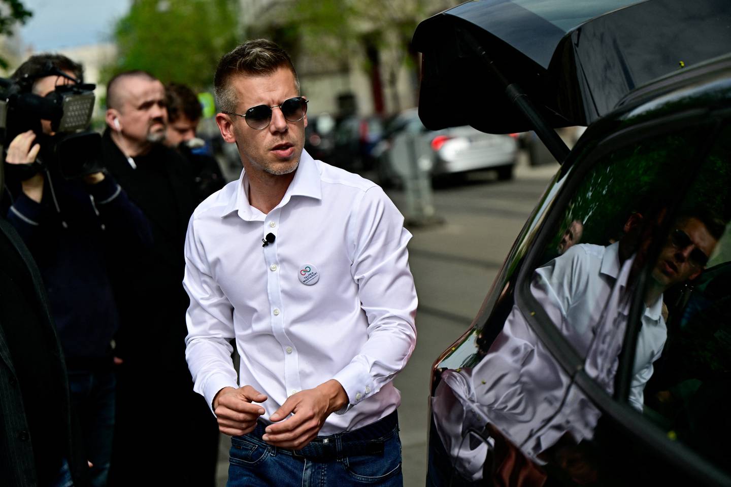 Peter Magyar, a lawyer and businessman formerly close to Hungary's ruling nationalist government, walks next to a car, in Budapest, Hungary, April 6, 2024. REUTERS/Marton Monus
