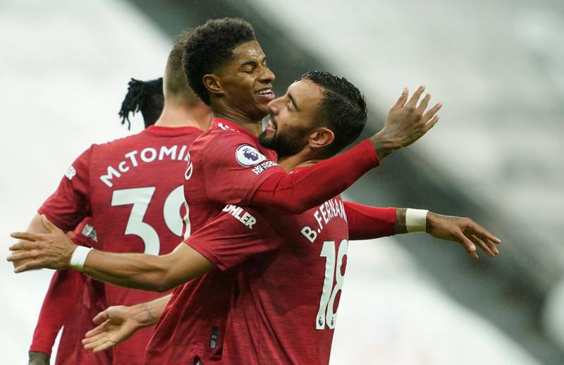 Manchester United's Marcus Rashford, centre, celebrates his goal during the English Premier League soccer match between Newcastle United and Manchester United at St. James' Park in Newcastle, England, Saturday, Oct. 17, 2020. (Owen Humphreys/PA via AP)