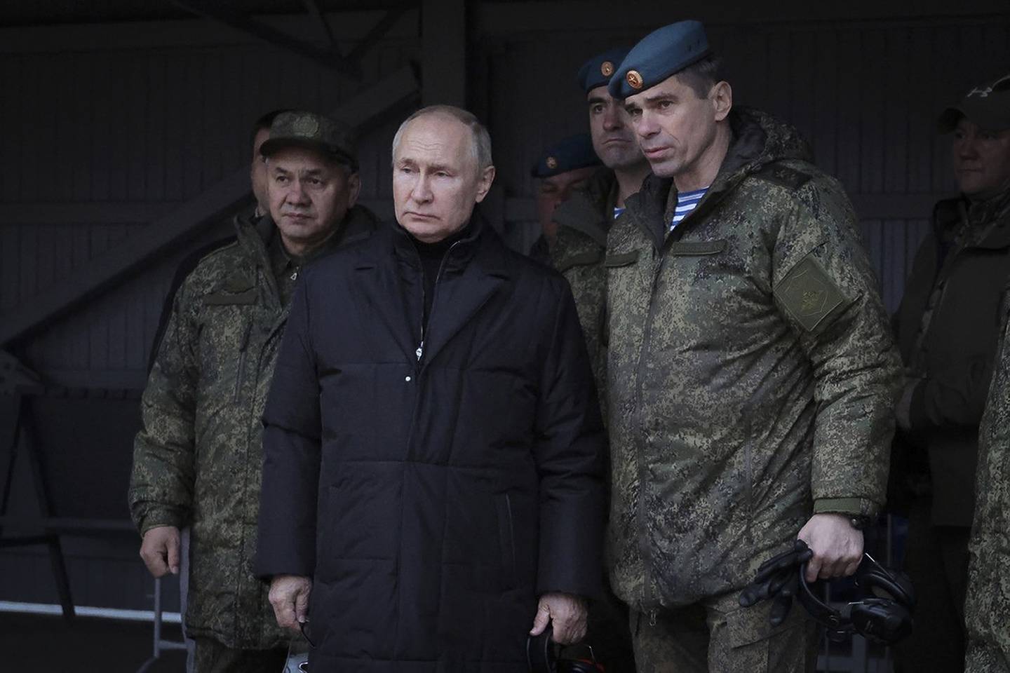 In this handout photo released by Russian Defense Ministry Press Service, Russian President Vladimir Putin, center, Russian Defense Minister Sergei Shoigu, left, and Deputy Commander of the Airborne Troops Anatoly Kontsevoy, visit a military training centre of the Western Military District for mobilised reservists in Ryazan Region, Russia, Thursday, Oct. 20, 2022. (Russian Defense Ministry Press Service via AP)