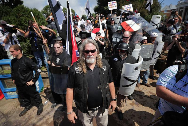 CHARLOTTESVILLE, VA - AUGUST 12: White nationalists, neo-Nazis and members of the "alt-right" exchange insluts with counter-protesters as they attempt to guard the entrance to Lee Park during the "Unite the Right" rally August 12, 2017 in Charlottesville, Virginia. After clashes with anti-fascist protesters and police the rally was declared an unlawful gathering and people were forced out of Lee Park, where a statue of Confederate General Robert E. Lee is slated to be removed.   Chip Somodevilla/Getty Images/AFP
== FOR NEWSPAPERS, INTERNET, TELCOS & TELEVISION USE ONLY ==