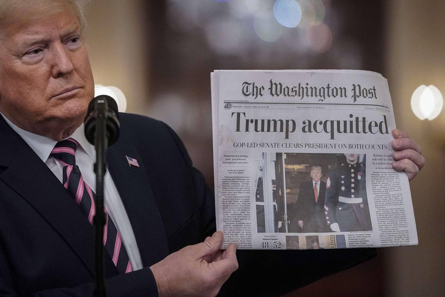 WASHINGTON, DC - FEBRUARY 06: U.S. President Donald Trump holds a copy of The Washington Post as he speaks in the East Room of the White House one day after the U.S. Senate acquitted on two articles of impeachment, ion February 6, 2020 in Washington, DC. After five months of congressional hearings and investigations about President Trumps dealings with Ukraine, the U.S. Senate formally acquitted the president on Wednesday of charges that he abused his power and obstructed Congress.   Drew Angerer/Getty Images/AFP
== FOR NEWSPAPERS, INTERNET, TELCOS & TELEVISION USE ONLY ==