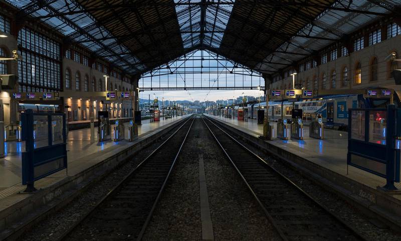 Railways are seen in the morning of a mass strike at the Gare St-Charles station in Marseille, southern France, Thursday, Dec. 5, 2019. Workers across the public sector fear President Emmanuel Macron's reform will force them to work longer and shrink their pensions. (AP Photo/Daniel Cole)