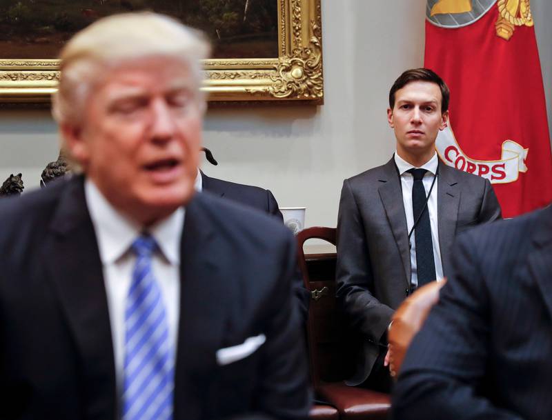 FILE - In this Jan. 23, 2017, file photo, White House Senior Adviser Jared Kushner listens at right as President Donald Trump speaks during a breakfast with business leaders in the Roosevelt Room of the White House in Washington. Kushner has been a power player able to avoid much of the harsh scrutiny that comes with working in the White House, but he's found that even the president's son-in-law takes his turn in the spotlight. (AP Photo/Pablo Martinez Monsivais, File)