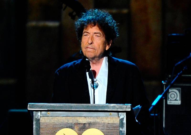 FILE - In this Feb. 6, 2015 file photo, Bob Dylan accepts the 2015 MusiCares Person of the Year award at the 2015 MusiCares Person of the Year show in Los Angeles. Dylans Tarantula, a stream-of-consciousness work first released in 1971, is finally coming out in audio. Simon & Schuster announced Tuesday, Oct. 15, 2019, that Will Patton is the narrator, reciting such lines as raggedy ann daughter of brazos and teeth in the necklace. Dylan first wrote Tarantula in the mid-1960s, at the height of his career. But his 1966 motorcycle accident delayed publication and made the book a kind of underground legend, with unauthorized versions turning up. (Photo by Vince Bucci/Invision/AP, File)