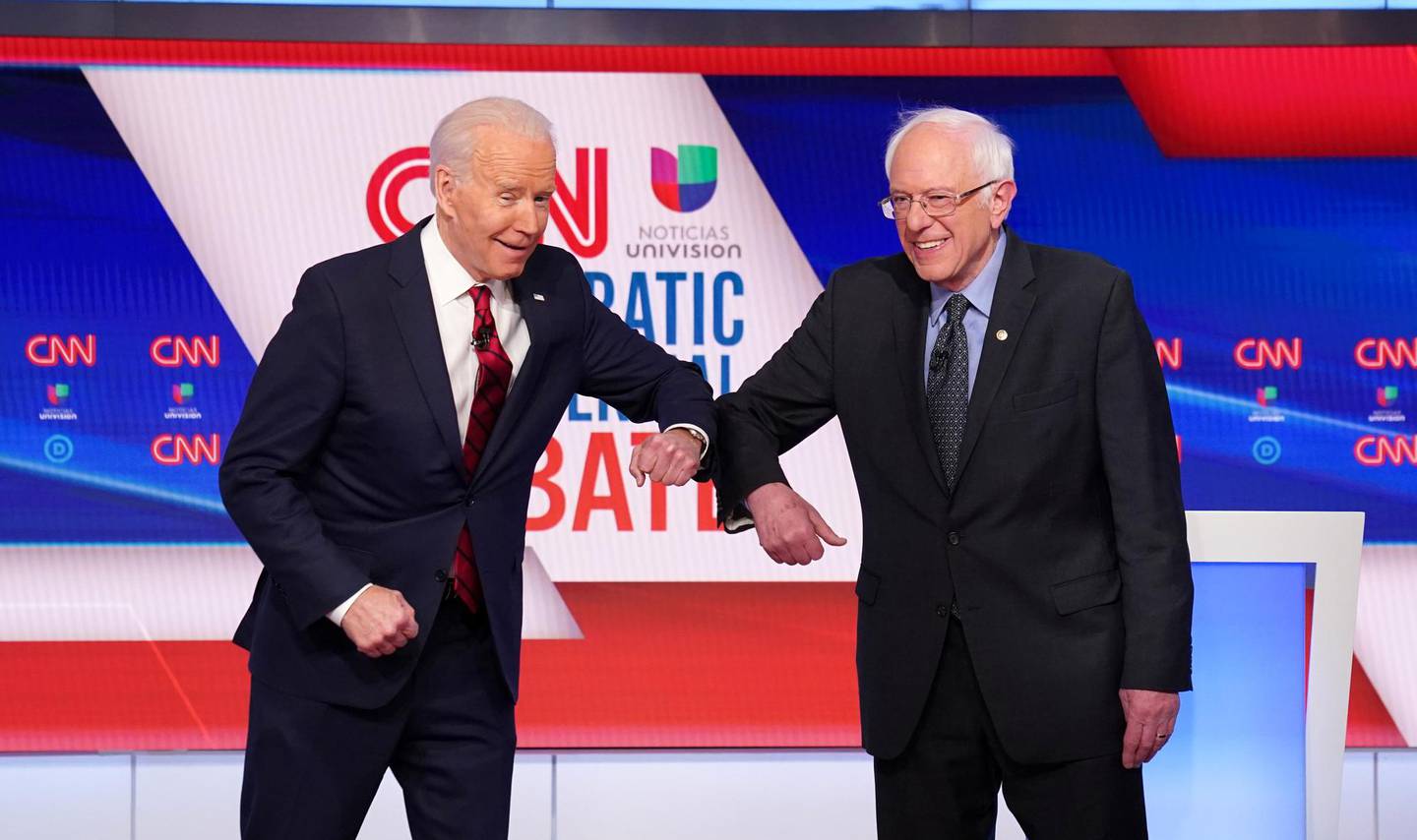 Democratic U.S. presidential candidates former Vice President Joe Biden and Senator Bernie Sanders do an elbow bump in place of a handshake as they greet other before the start of the 11th Democratic candidates debate of the 2020 U.S. presidential campaign, held in CNN's Washington studios without an audience because of the global coronavirus pandemic, in Washington, U.S. March 15, 2020. REUTERS/Kevin Lamarque     TPX IMAGES OF THE DAY