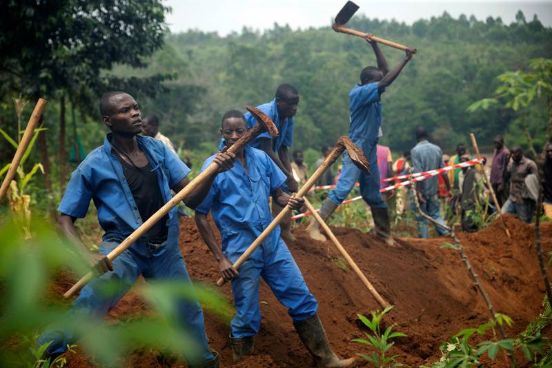 Burundian workers from the Truth and Reconciliation Commission dig to extract bodies from a mass grave in the Bukirasazi hill in Karusi Province, Burundi January 27, 2020. Picture taken January 27, 2020. REUTERS/Evrard Ngendakumana