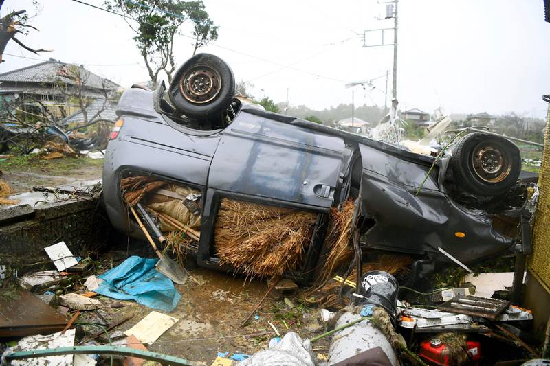 An overturned car lies on the ground following a strong wind in Ichihara, Chiba, near Tokyo Saturday, Oct. 12, 2019. Under gloomy skies, a tornado ripped through Chiba on Saturday.(Kyodo News via AP)