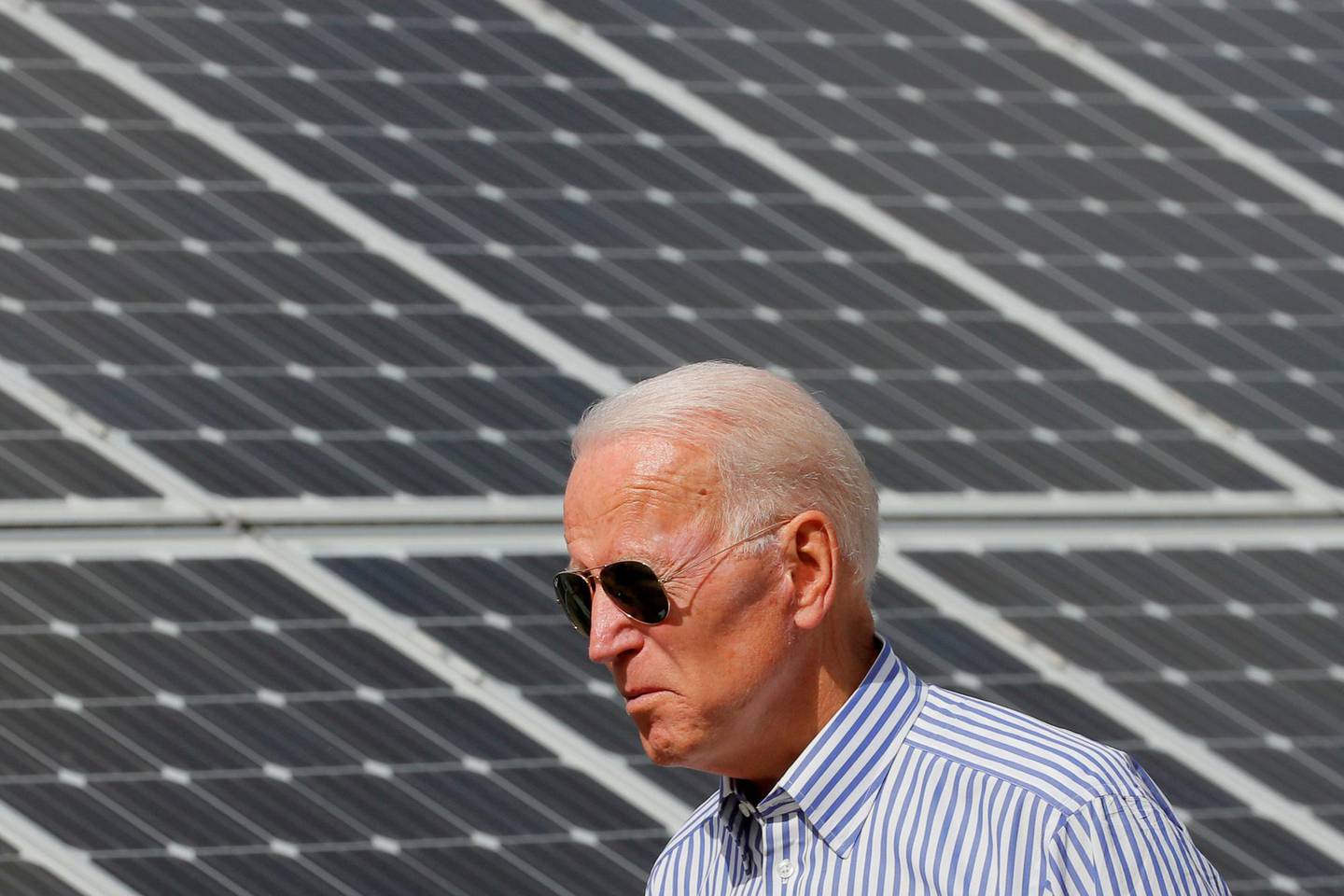 FILE PHOTO: Democratic 2020 U.S. presidential candidate and former Vice President Joe Biden walks past solar panels while touring the Plymouth Area Renewable Energy Initiative in Plymouth, New Hampshire, U.S., June 4, 2019.   REUTERS/Brian Snyder/File Photo/File Photo