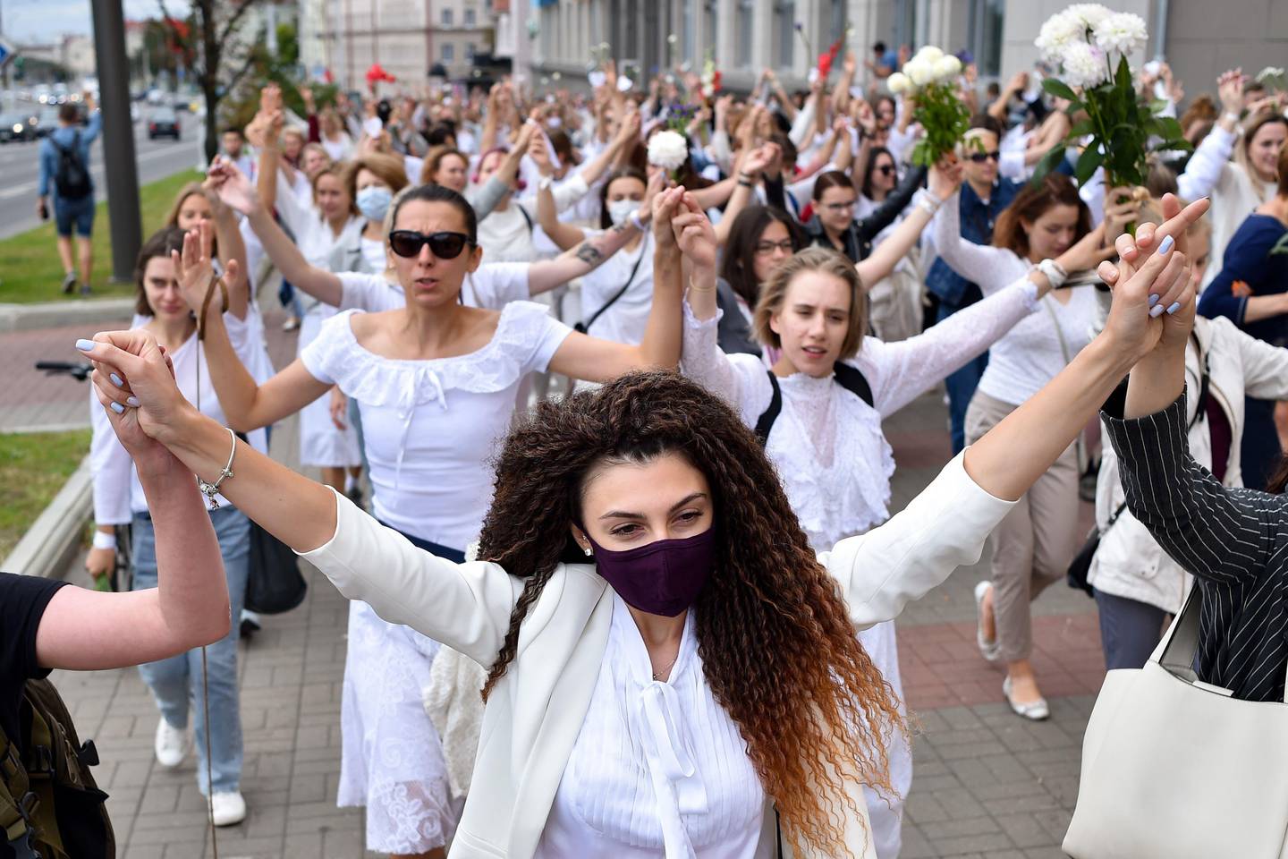Women dressed in white clothes protest against police violence during recent rallies of opposition supporters, who accuse strongman Alexander Lukashenko of falsifying the polls in the presidential election, in Minsk on August 12, 2020. (Photo by Sergei GAPON / AFP)
