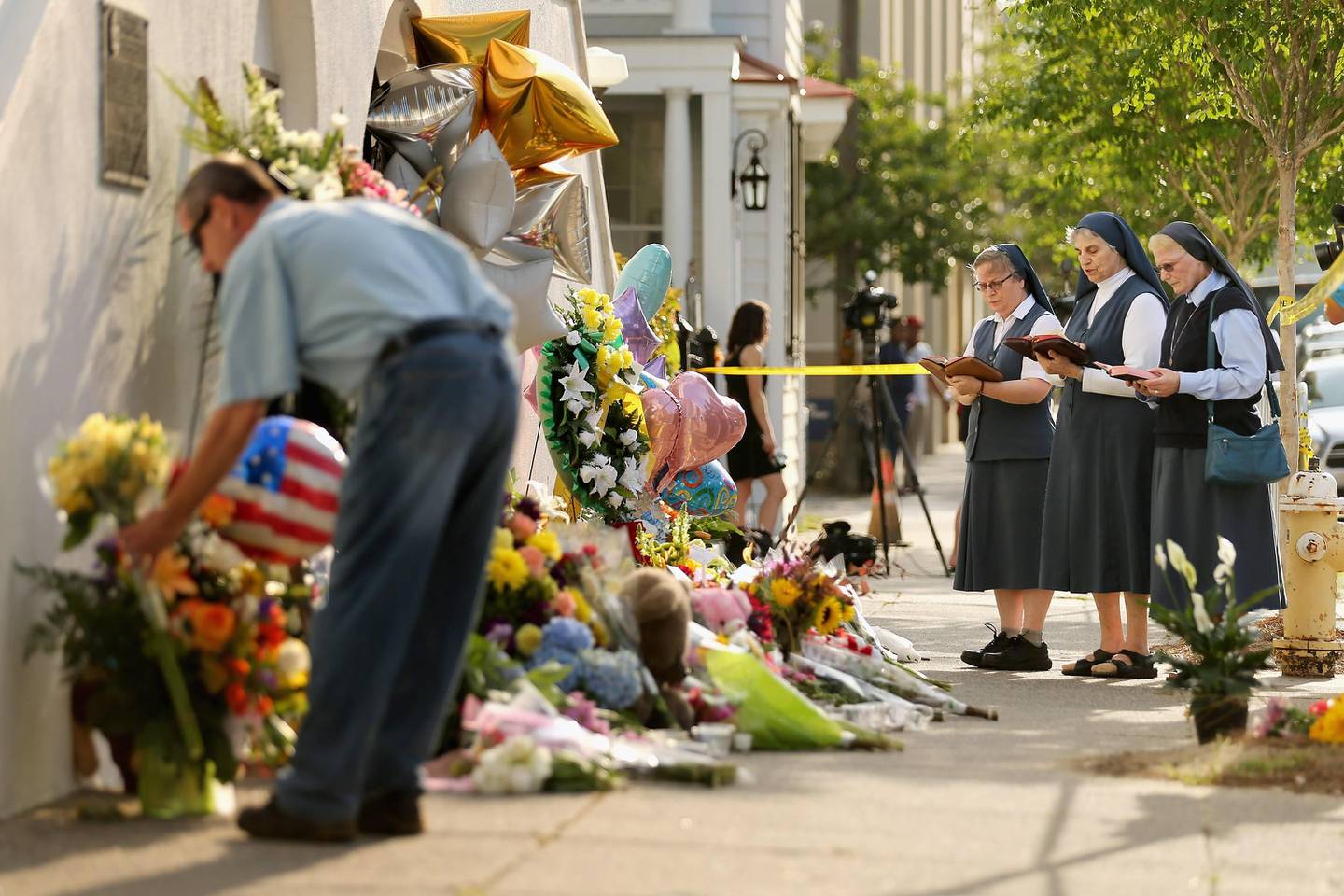CHARLESTON, SC - JUNE 19: (L-R) Sisters Margaret Kerry, Mary Thecla and Kathleen Lang of the Order of the Daughters of St. Paul pray outside the historic Emanuel African Methodist Episcopal Church June 19, 2015 in Charleston, South Carolina. South Carolina Governor Nikki Haley called for the death penalty for Dylann Storm Roof, 21, of Lexington, South Carolina, if he is found guilty of murdering nine people during a prayer meeting at the church Wednesday night. Among the dead is the Rev. Clementa Pinckney, the pastor of the church which, according to the National Park Service, is the oldest black congregation in America south of Baltimore.   Chip Somodevilla/Getty Images/AFP
== FOR NEWSPAPERS, INTERNET, TELCOS & TELEVISION USE ONLY ==