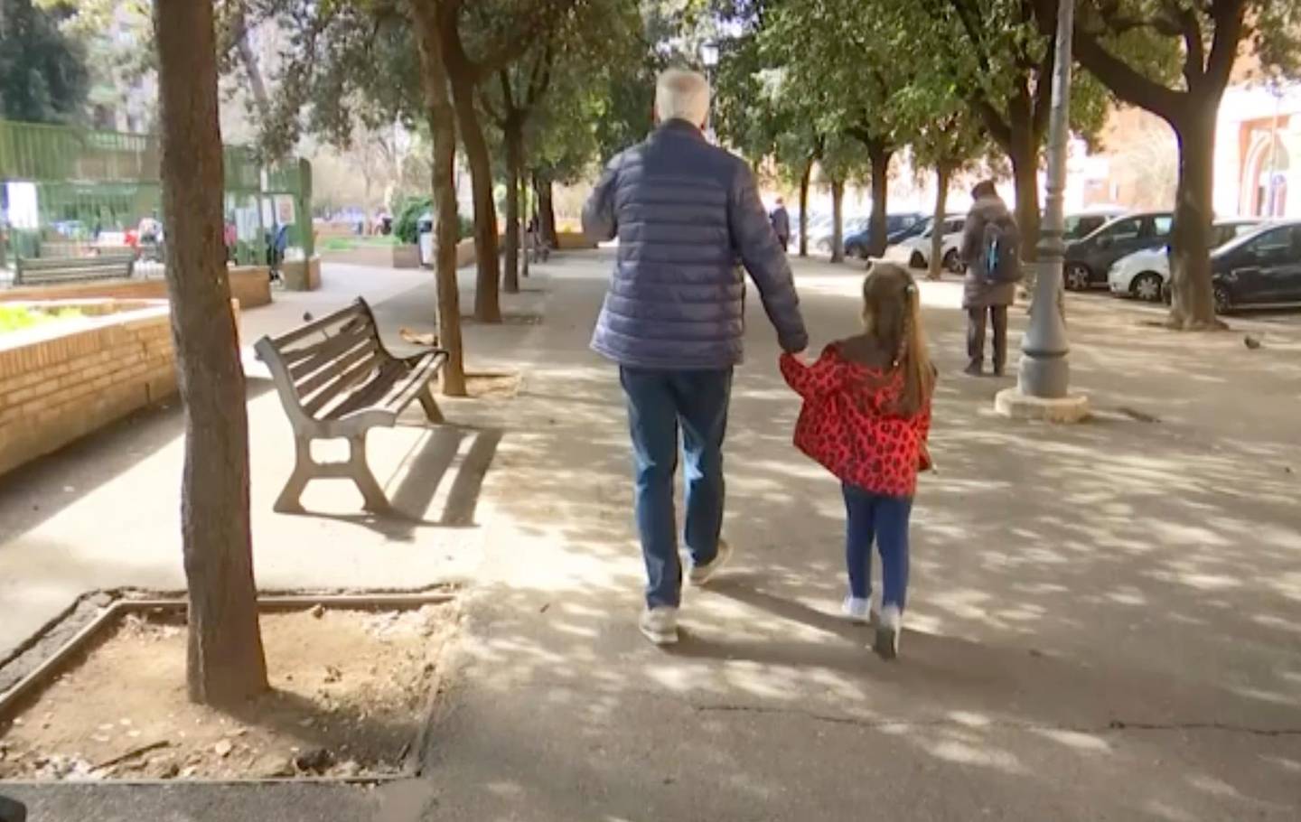 A young girl walk with her elderly grandparent along a tree lined avenue in Rome, Italy, Thursday March 5, 2020, after the Italian government closed all schools to assist in the fight against the COVID-19 virus. Some of the most vulnerable people, grandparents, have been forced to face possible virus infection as they look after young family members in playgrounds and parks in the city.(AP Photo)