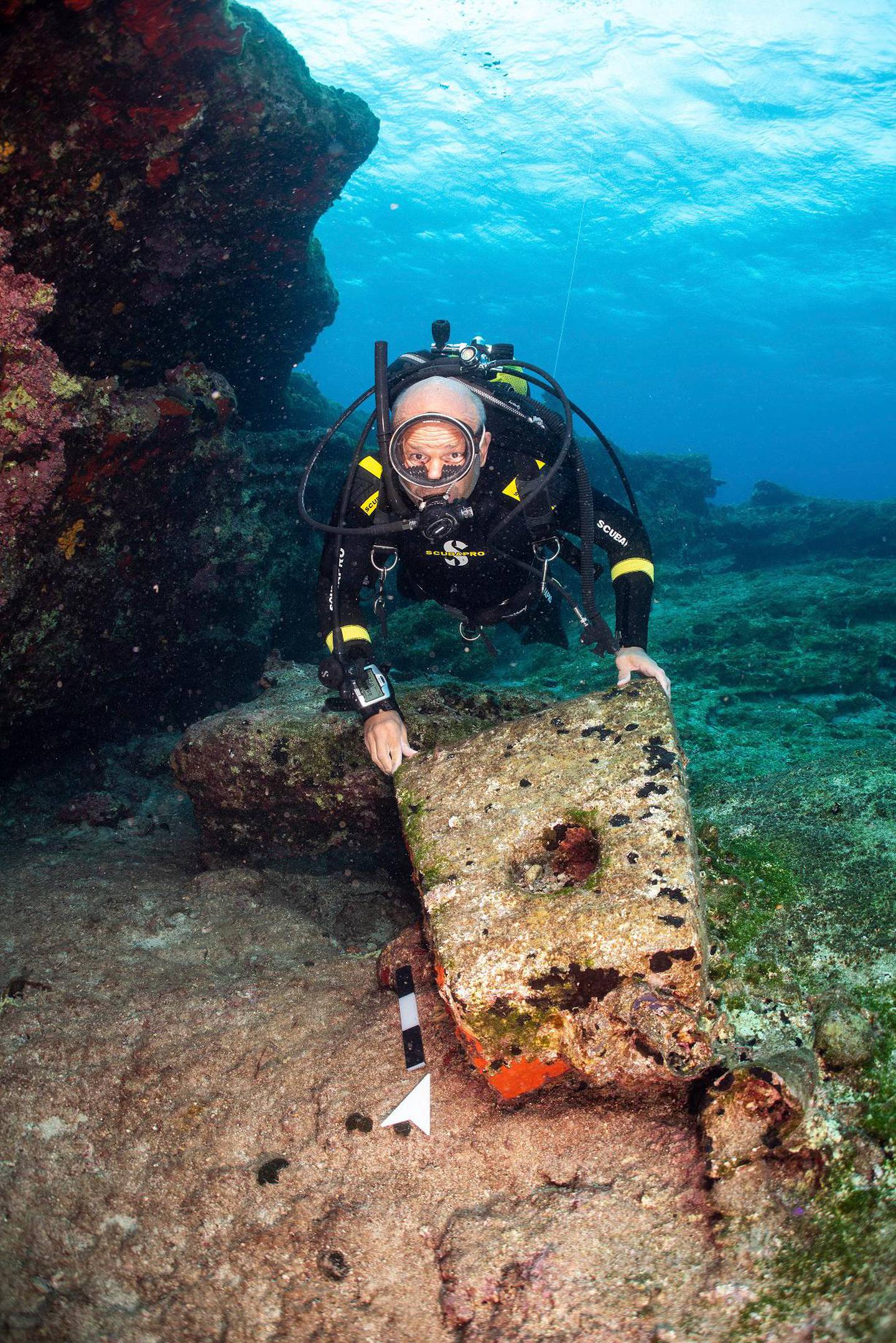In this undated photo provide by the Greek Culture Ministry on Monday, Nov. 4, 2019, an archeologist takes part in an underwater excavation at the small Aegean island of Kasos, Greece. Greece's Culture Ministry says three shipwrecks from ancient and mediaeval times and large sections of their cargoes have been discovered off the island of Kasos. (Frode Kvalo/Greek Culture Ministry via AP)