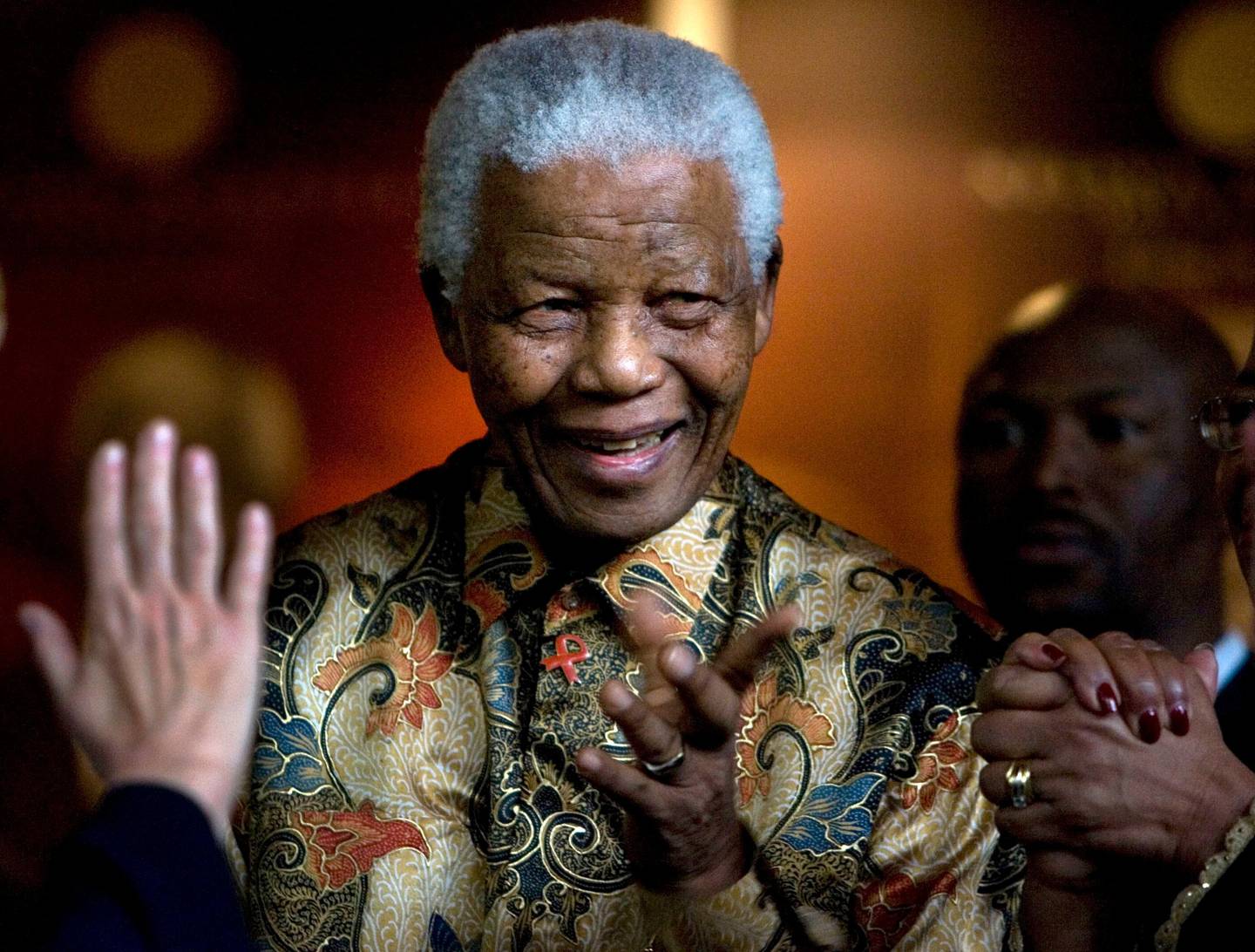FILE - In this Oct. 6, 2007, file photo, former South African President Nelson Mandela reacts after a meeting at the Nelson Mandela Foundation building in Johannesburg, South Africa. The centennial of Mandela's birth is July 18, and those wishing to make a pilgrimage to honor his legacy will find a number of sites around South Africa, from the villages of his childhood to museums and historic sites about apartheid. (AP Photo/Peter Dejong, File)