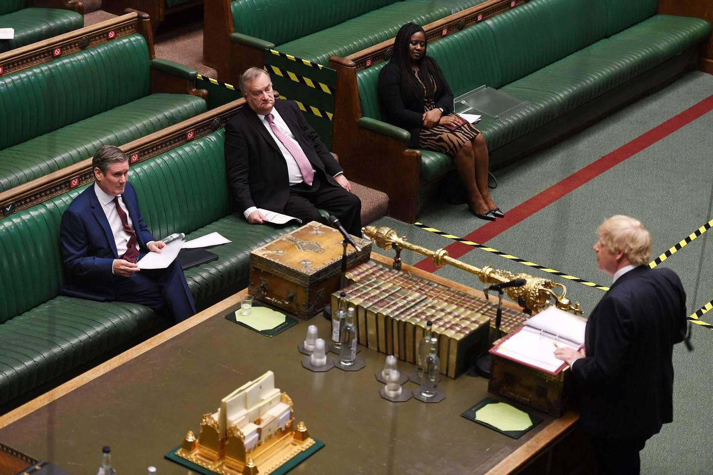 A handout photograph released by the UK Parliament shows shows Britain's main opposition Labour Party leader Keir Starmer (L) listening as Britain's Prime Minister Boris Johnson speaks at Prime Minister's Question time (PMQs) in the House of Commons in London on May 6, 2020, as parliament continues with social distancing measures in place, and some MPs taking part remotely by videolink, due to the novel coronavirus COVID-19 pandemic. - British Prime Minister Boris Johnson said Wednesday he could begin to ease a nationwide coronavirus lockdown next week, but warned he would do nothing that would risk a new surge of cases. He was speaking the day after Britain overtook Italy to become the worst-hit country in Europe, with more than 32,000 deaths related to COVID-19 -- behind only the United States in the global rankings. (Photo by JESSICA TAYLOR / various sources / AFP) / RESTRICTED TO EDITORIAL USE - NO USE FOR ENTERTAINMENT, SATIRICAL, ADVERTISING PURPOSES - MANDATORY CREDIT " AFP PHOTO / Jessica Taylor /UK Parliament"