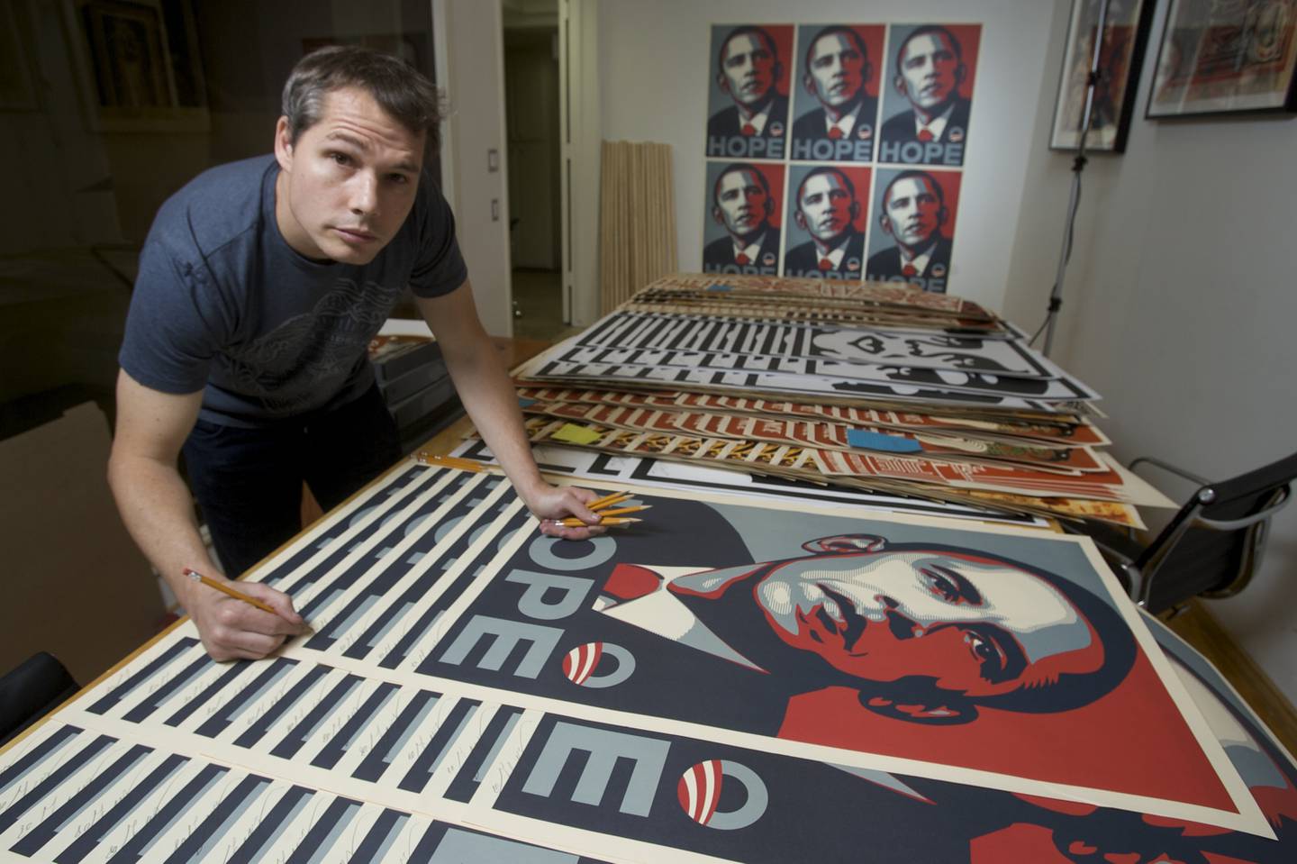 Los Angeles street artist Shepard Fairey signs his Barack Obama Hope artwork in the Echo Park area of Los Angeles on Monday, Jan. 12, 2009. Fairey is the designer of the famous Obama campaign poster and also the Obey-Andre the Giant poster of a few years back. (AP Photo/Damian Dovarganes)