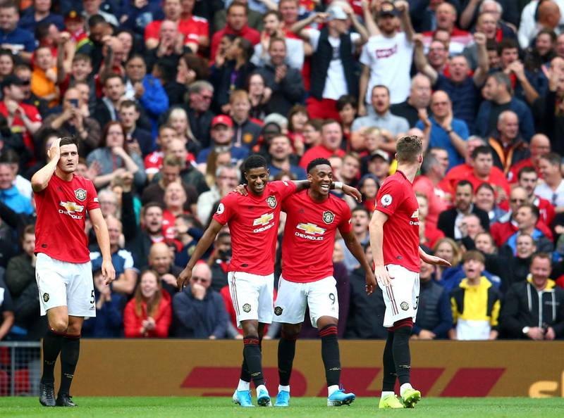 Manchester United's Anthony Martial, 2nd right, celebrates with teammates after scoring his sides second goal during the English Premier League soccer match between Manchester United and Chelsea at Old Trafford in Manchester, England, Sunday, Aug. 11, 2019. (AP Photo/Dave Thompson)