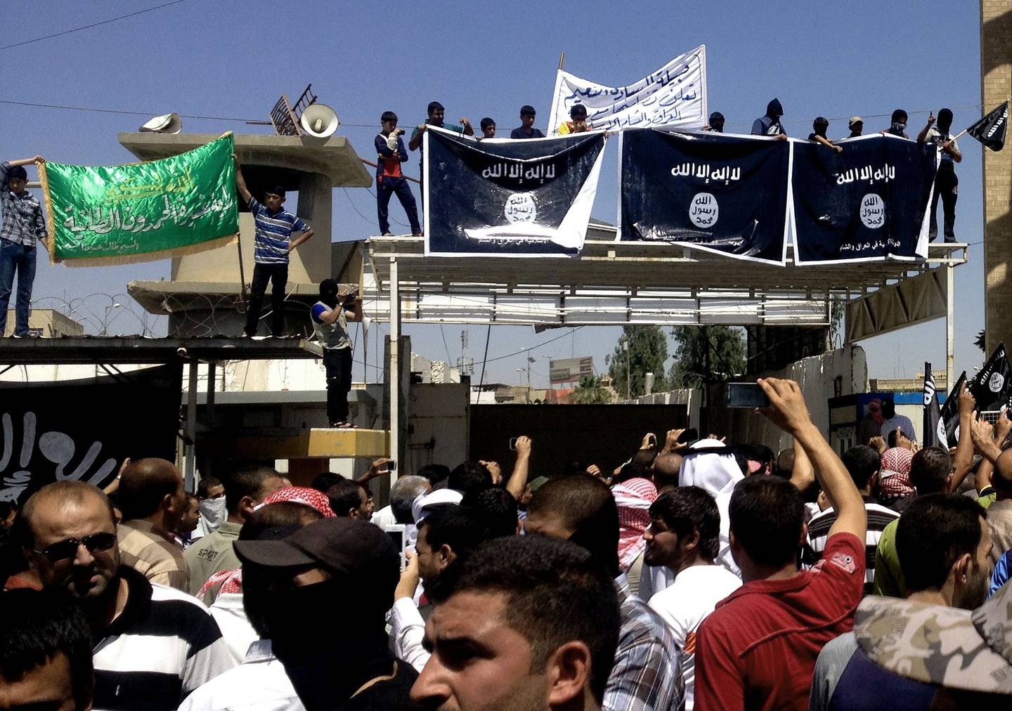 Demonstrators chant pro-al-Qaida-inspired Islamic State of Iraq and the Levant in front of the provincial government headquarters in Mosul, 225 miles (360 kilometers) northwest of Baghdad, Iraq, Monday, June 16, 2014. Sunni militants captured a key northern Iraqi town along the highway to Syria early on Monday, compounding the woes of Iraq's Shiite-led government a week after it lost a vast swath of territory to the insurgents in the country's north. (AP Photo)