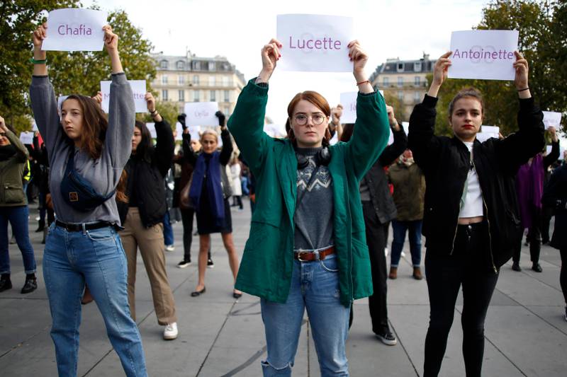 FILE - In this Oct.19, 2019 file photo, women hold placards with the names of women killed by their partners, during a protest, in Paris. France, a country that has prided itself on gender equality, is beginning to pay serious attention to its yet-intractable problem of domestic violence. (AP Photo/Thibault Camus, File)