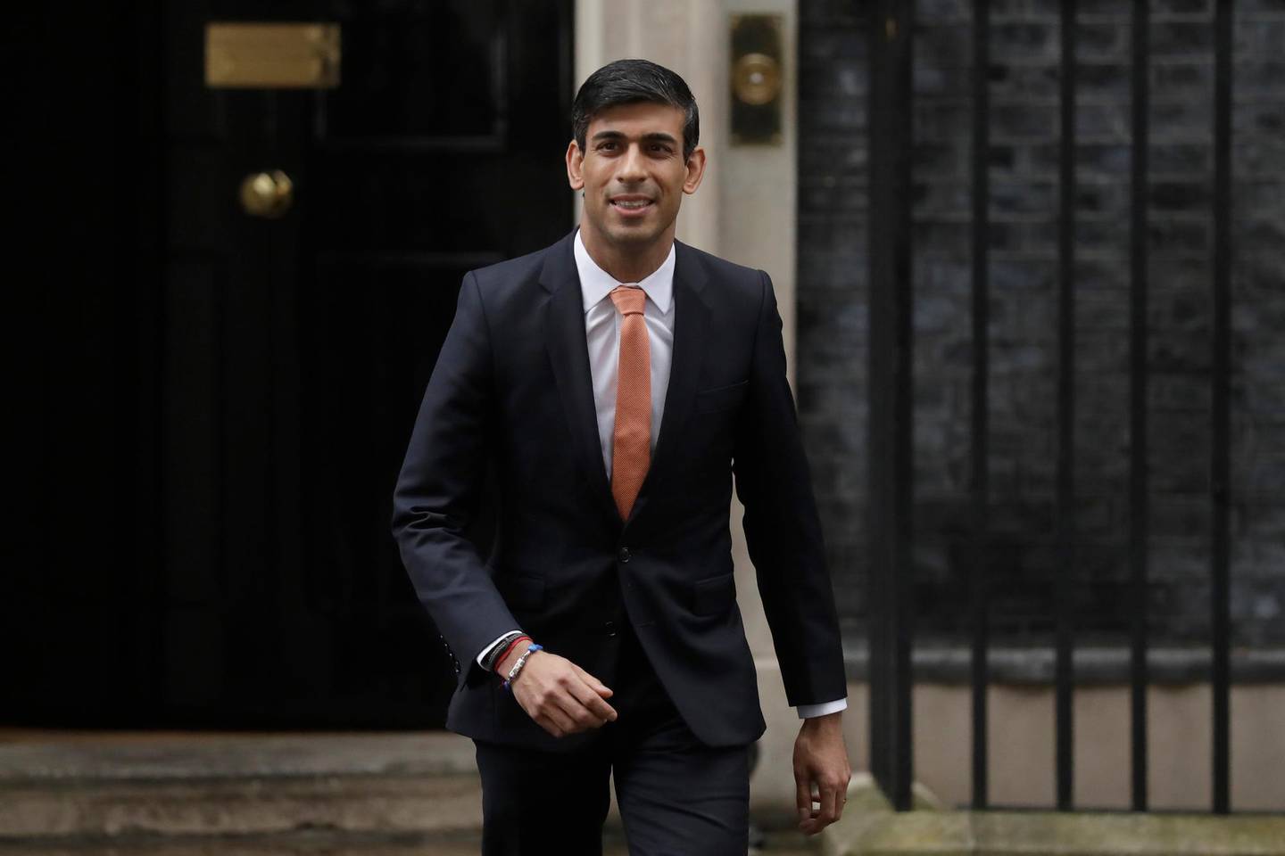 British lawmaker Rishi Sunak, and Chancellor of the Exchequer leaves 10 Downing Street, where he was given the job by Britain's Prime Minister Boris Johnson, as the former Chancellor Sajid Javid, resigned, in London, Thursday, Feb. 13, 2020. British Prime Minister Boris Johnson shook up his government on Thursday, firing and appointing ministers to key Cabinet posts. Johnson was aiming to tighten his grip on government after winning a big parliamentary majority in December's election. That victory allowed Johnson to take Britain out of the European Union in January. (AP Photo/Matt Dunham)