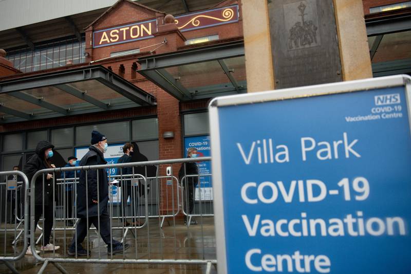 Members of the public arrive to receive a dose of a Covid-19 vaccine, at a temporary coronavirus vaccination hub set up at Villa Park football stadium, home ground of English Premiere League football team Aston Villa, in Birmingham, central England on February 4, 2021. - Oxford University announced on Thursday it will launch a medical trial alternating doses of Covid-19 vaccines created by different manufacturers, the first study of its kind. (Photo by Jacob King / POOL / AFP)