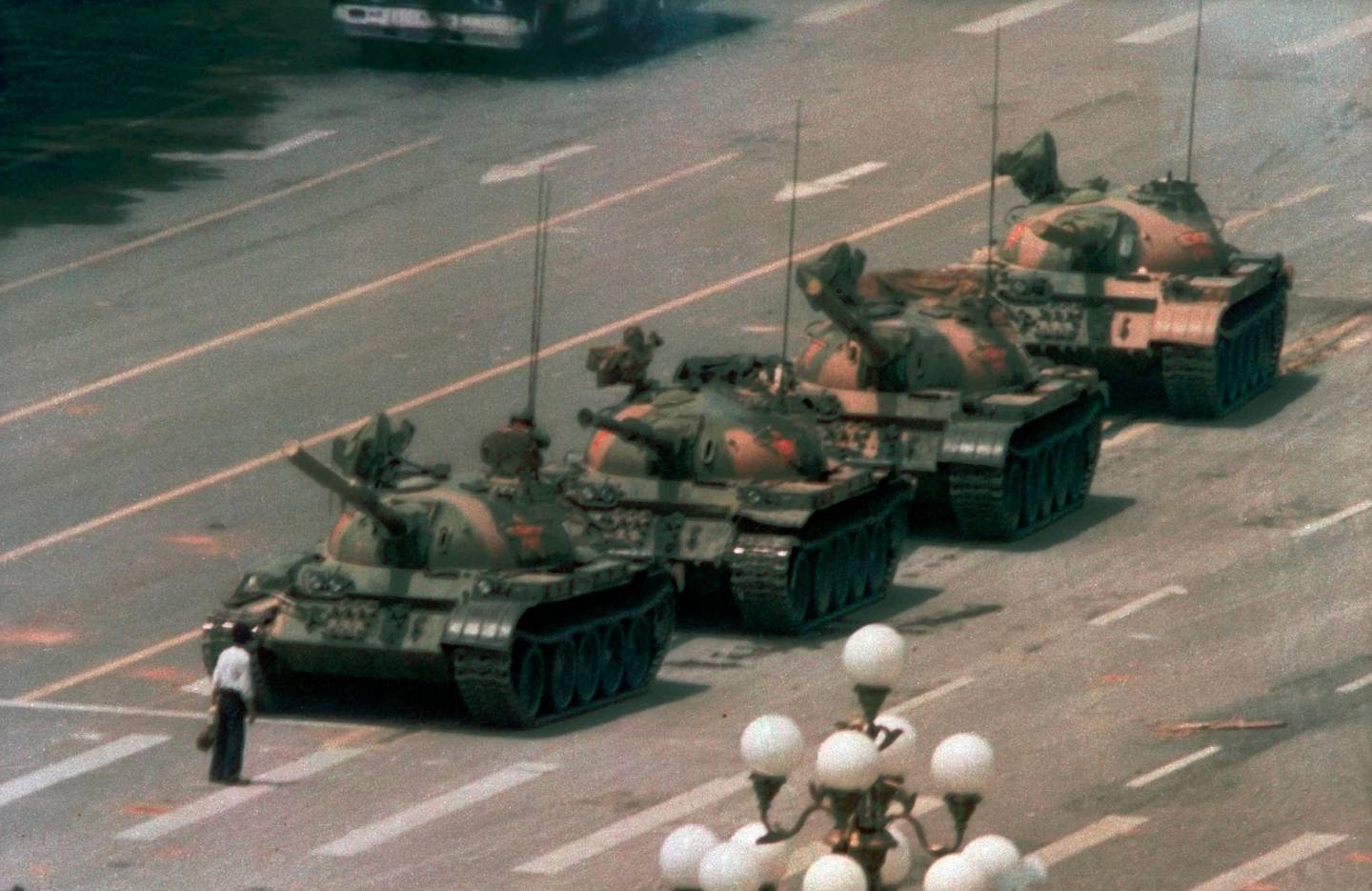 FILE - In this June 5, 1989 file photo, a Chinese man stands alone to block a line of tanks heading east on Beijing's Changan Blvd. in Tiananmen Square. The man, calling for an end to the recent violence and bloodshed against pro-democracy demonstrators, was pulled away by bystanders, and the tanks continued on their way. Over seven weeks in 1989, student-led pro-democracy protests centered on BeijingÄôs Tiananmen Square became ChinaÄôs greatest political upheaval since the end of the Cultural Revolution more than a decade earlier.(AP Photo/Jeff Widener, File )