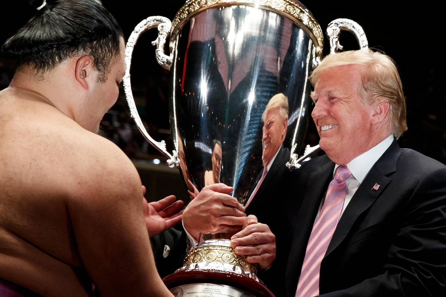 President Donald Trump presents the "President's Cup" to Tokyo Grand Sumo Tournament winner Asanoyama, at Ryogoku Kokugikan Stadium, Sunday, May 26, 2019, in Tokyo. (AP Photo/Evan Vucci)