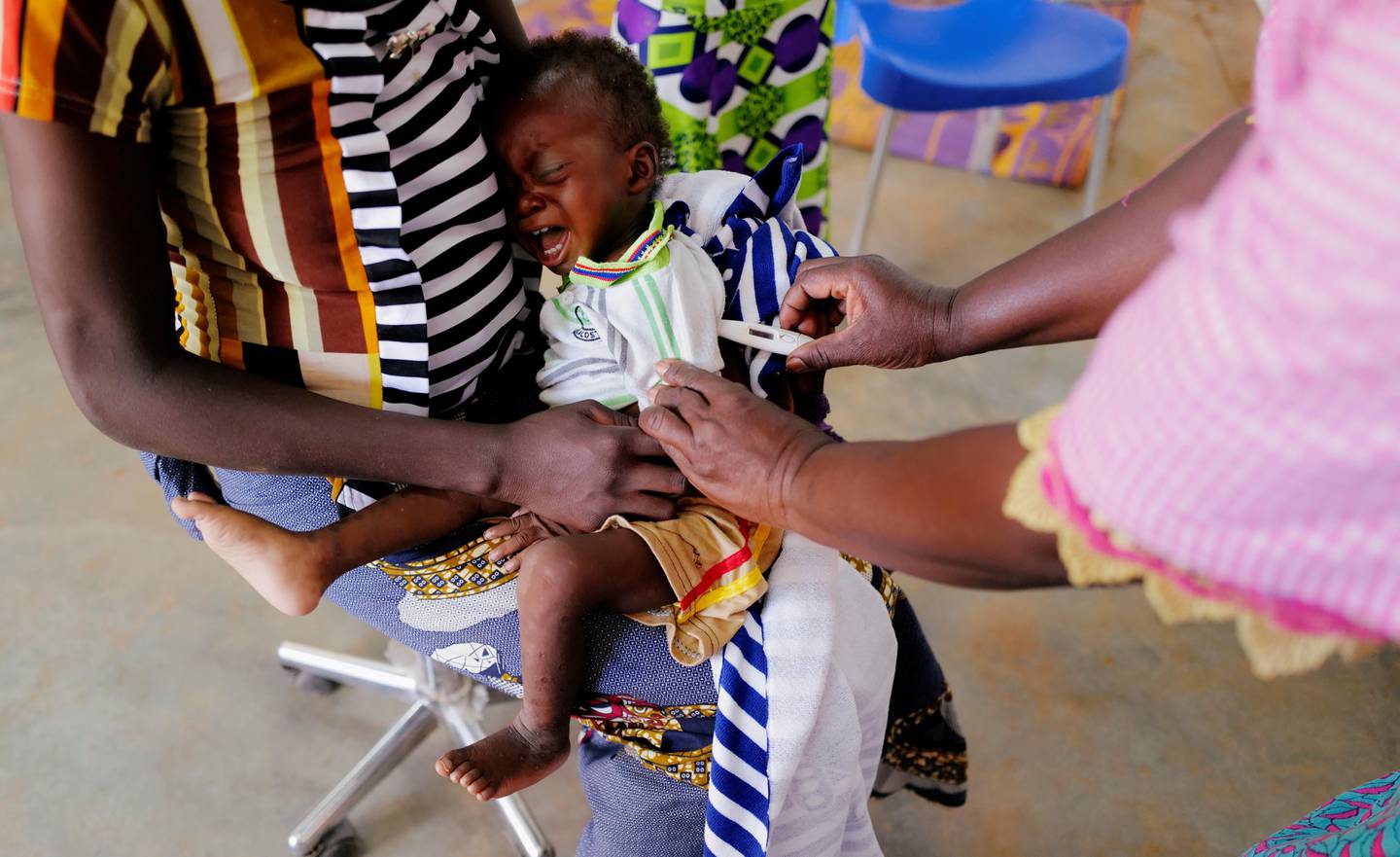 Hassan, a sixteen-month-old child who suffers from malnutrition, cries as a nurse checks his temperature at the hospital in Kaya, Burkina Faso November 23, 2020. Picture taken November 23, 2020.REUTERS/Zohra Bensemra