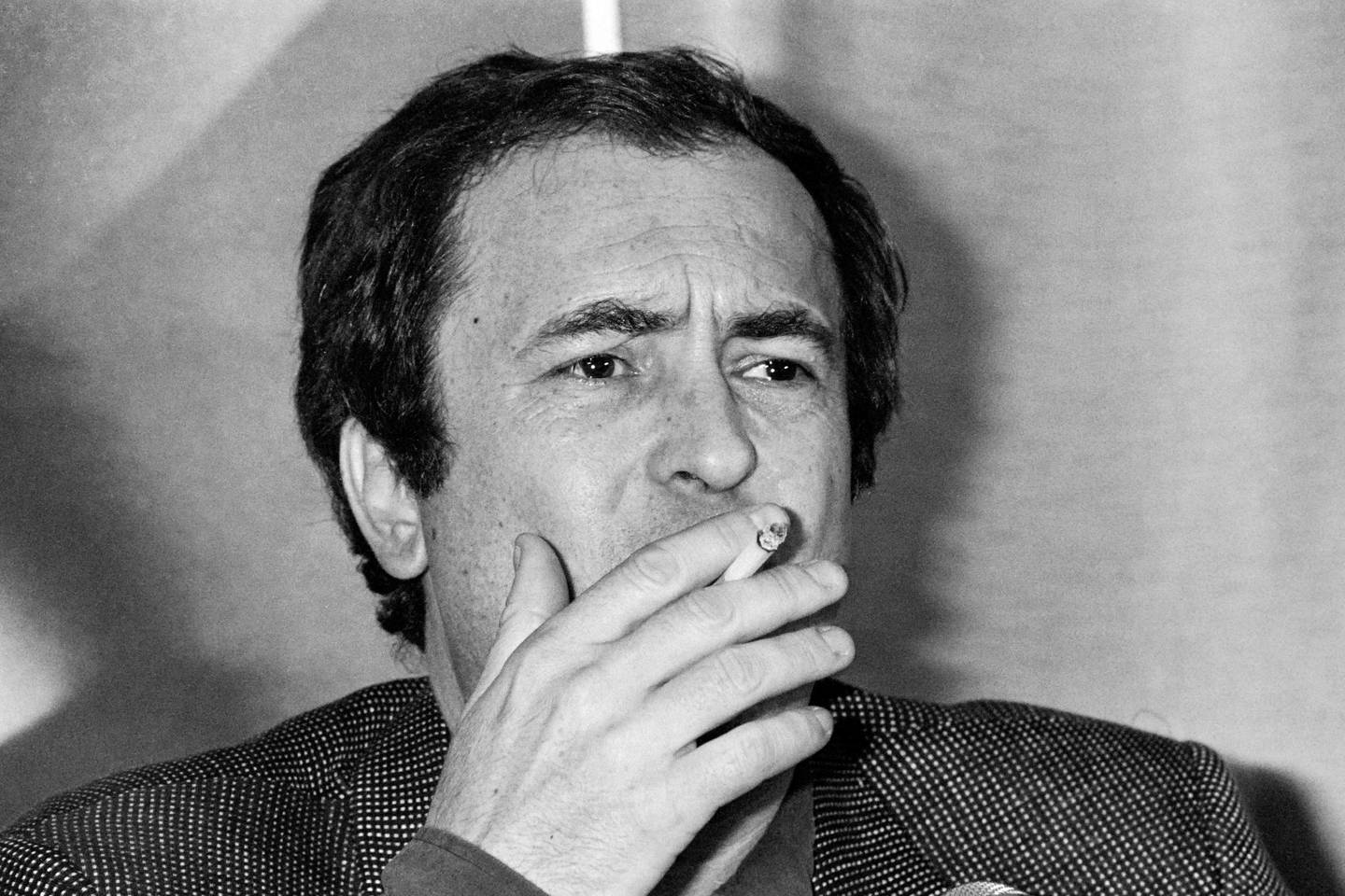 A picture taken on May 25, 1981 in Cannes shows Italien director Bernardo Bertolucci smoking as he presents his movie "Tragedy of a ridiculous man" during the 34th Cannes film festival. - Italian film director Bernardo Bertolucci, whose films include 'Last Tango In Paris' and 'The Last Emperor', has died in Rome aged 77, Italian media said on November 28, 2018. (Photo by Ralph GATTI / AFP)
