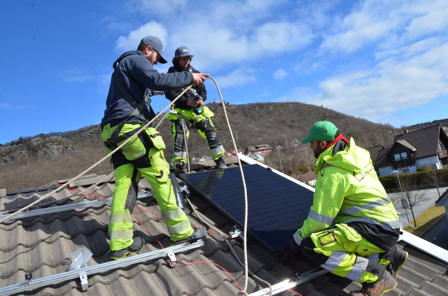 Ruben Madsen, Simen Trondsen og Ibrahim Alajour monterer solcellepanel på en enebolig på Hommersåk. Montrøene har det travelt. Interessen for solcellepanel øker i takt med den økte strømprisen.