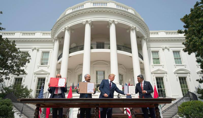 President Donald Trump, center, with, from left, Bahrain Foreign Minister Khalid bin Ahmed Al Khalifa, Israeli Prime Minister Benjamin Netanyahu, and United Arab Emirates Foreign Minister Abdullah bin Zayed al-Nahyan, during the Abraham Accords signing ceremony on the South Lawn of the White House, Tuesday, Sept. 15, 2020, in Washington. (AP Photo/Alex Brandon)