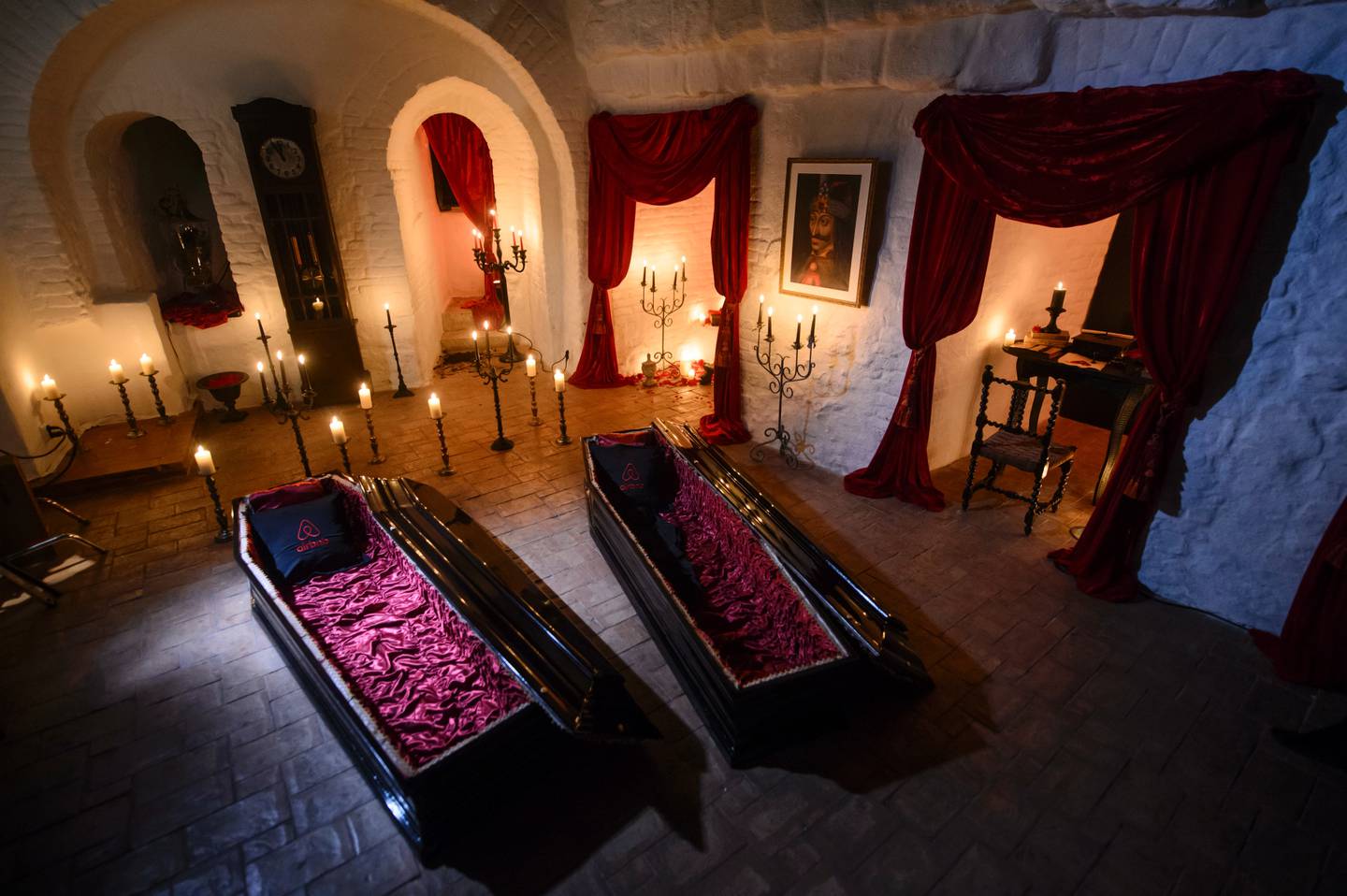 In this picture taken Oct. 9, 2016, two coffins are lit before a photo shoot in Bran Castle, in Bran, Romania. Airbnb has launched a contest to find two people to stay overnight in the castle on Halloween, popularly known as Dracula‚Äôs castle because of its connection to the cruel real-life prince Vlad the Impaler, who inspired the legend of Dracula. (AP Photo/Andreea Alexandru)