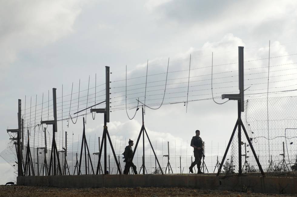 Israeli soldiers patrol along a fence to prevent Palestinian labourers, who do not have work permits, from sneaking into Israel for work amid concerns about the spread of the coronavirus, in the Israeli-occupied West Bank, April 7, 2020. Picture taken April 7, 2020. REUTERS/Raneen Sawafta