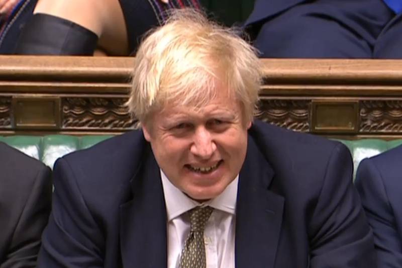 A still image taken from footage broadcast by the UK Parliamentary Recording Unit (PRU) on December 19, 2019 shows Britain's Prime Minister Boris Johnson reacting as Britain's Labour Party leader Jeremy Corbyn (unseen) speaks in the House of Commons in London after the State Opening Of Parliament. - Prime Minister Boris Johnson on Thursday put Britain's departure from the EU at the top of the agenda, as Queen Elizabeth II read out his plans for government in a parliamentary ceremony following a sweeping election win. (Photo by - / PRU / AFP) / RESTRICTED TO EDITORIAL USE - MANDATORY CREDIT " AFP PHOTO / PRU " - NO USE FOR ENTERTAINMENT, SATIRICAL, MARKETING OR ADVERTISING CAMPAIGNS