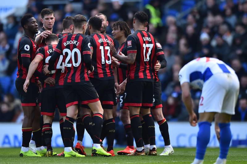 Bournemouth's English midfielder Dan Gosling celebrates with teammates after he scores the team's first goal during the English Premier League football match between Brighton and Hove Albion and Bournemouth at the American Express Community Stadium in Brighton, southern England on April 13, 2019. (Photo by Glyn KIRK / AFP) / RESTRICTED TO EDITORIAL USE. No use with unauthorized audio, video, data, fixture lists, club/league logos or 'live' services. Online in-match use limited to 120 images. An additional 40 images may be used in extra time. No video emulation. Social media in-match use limited to 120 images. An additional 40 images may be used in extra time. No use in betting publications, games or single club/league/player publications. / 