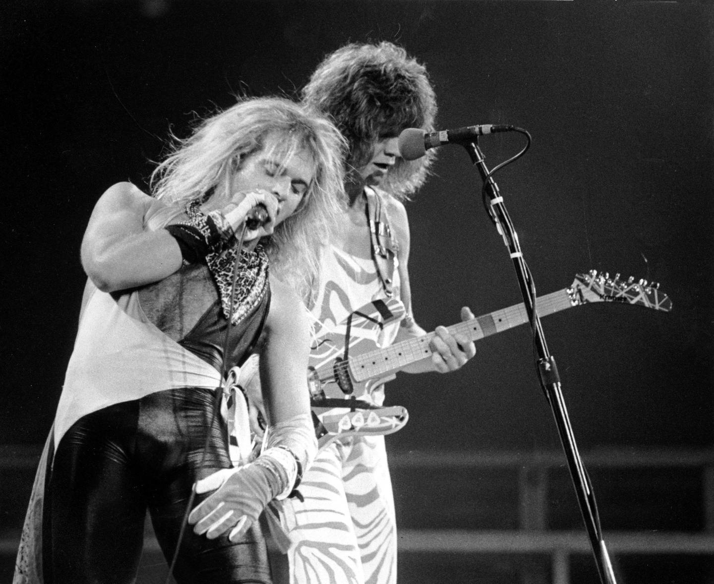 ** FILE ** Lead singer David Lee Roth, left, and lead guitarist  Eddie Van Halen of the rock group Van Halen perform during the concert at the spectrum in Philadelphia in this Oct. 19, 1982 file photo. The rockers have re-formed with original frontman David Lee Roth and will set out on a national tour beginning in October, 2007, according to a report posted Wednesday, Aug. 8, 2007 on Billboard Magazine's Web site. (AP Photo0